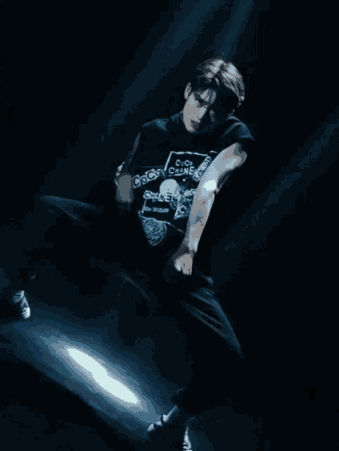 a man wearing a black t-shirt that says coca cola on it