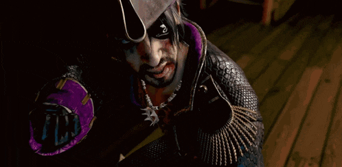 a man with blood on his face holds a black glove in his hand