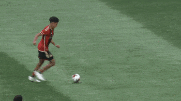 a soccer goalie dives to block a shot in front of a continental ad