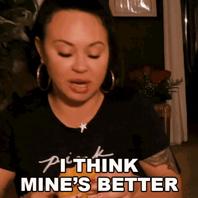 a woman wearing a black shirt with the words " i think mine 's better "