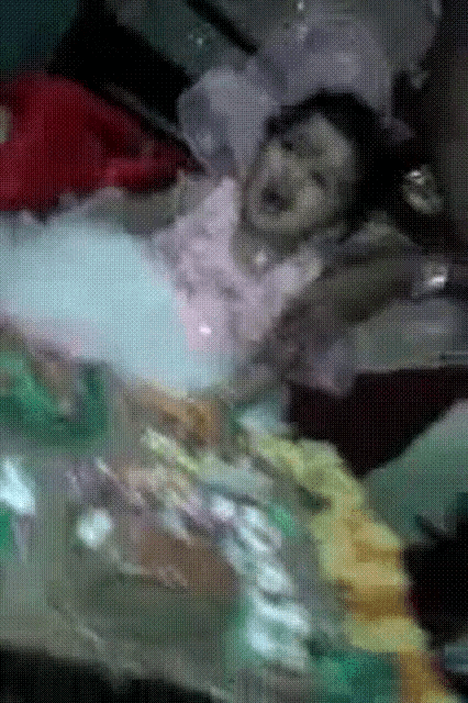 a woman in a white dress is laying in a bathtub with bubbles coming out of her mouth