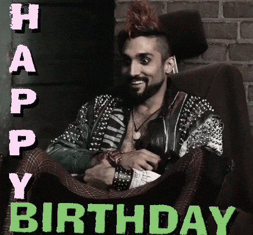 a man with a mohawk and studded jacket is sitting in a chair with the words happy birthday behind him