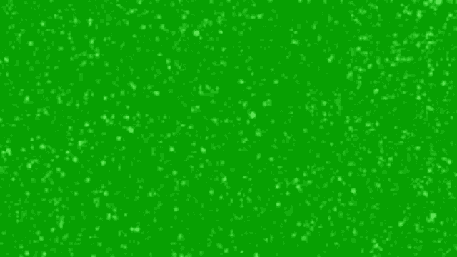 it looks like snow is falling on a green background .