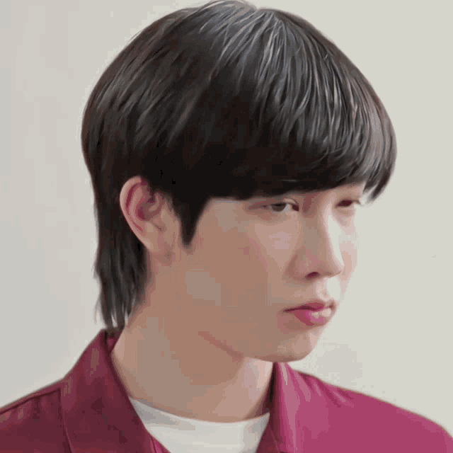 a close up of a person 's face with a mullet hairstyle