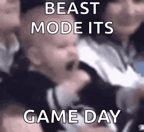 a baby is crying in a crowd of people with the words `` beast mode its game day '' written above it .