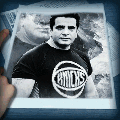 a black and white photo of a man wearing a knicks t shirt