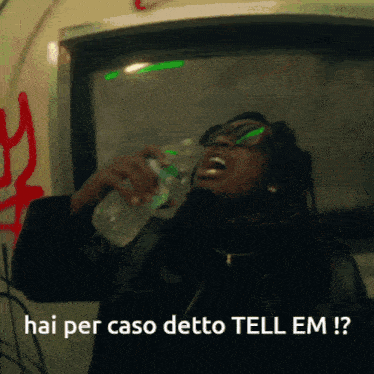 a man drinking from a bottle with the words hai per caso detto tell em written below him