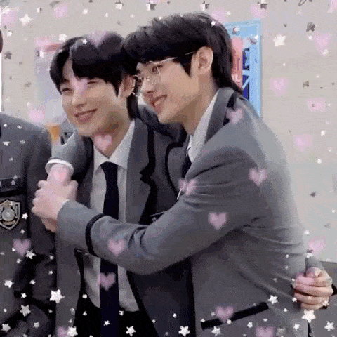 a couple of men hugging each other in a room .