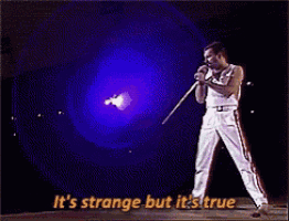 a man singing into a microphone with the words it 's strange but it 's true