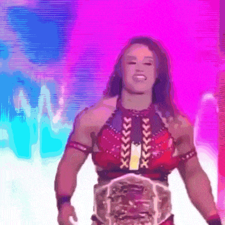 a female wrestler is wearing a belt that says ' x ' on it