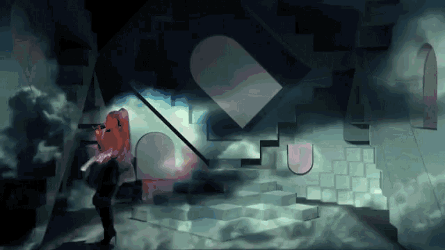 a woman singing into a microphone in a room with stairs and arches