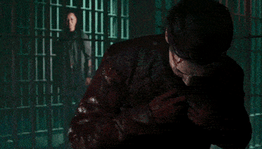 a man with blood on his face is in a dark room
