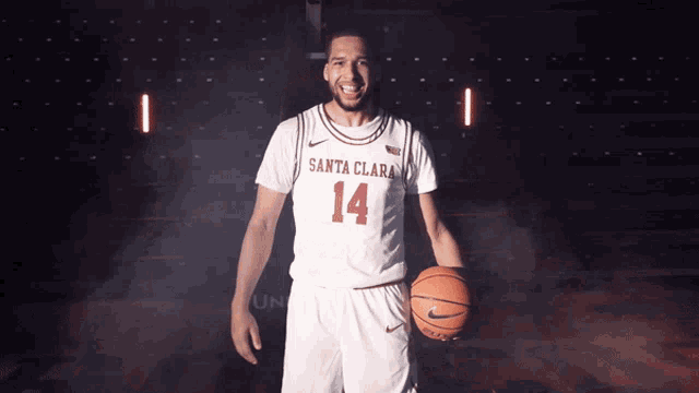 a basketball player from santa clara is holding a basketball