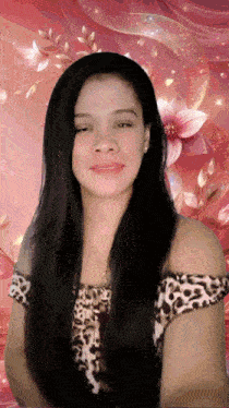a woman in a leopard print top stands in front of a pink background