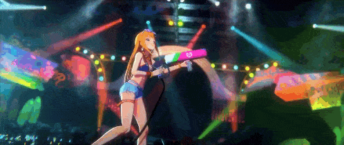 a girl in a bikini is holding a water gun on a stage in front of a crowd