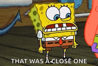 spongebob squarepants and patrick star are standing next to each other on a boat .