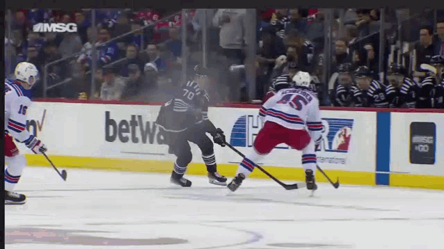 a hockey game is being played in front of a betwa ad