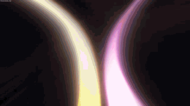 a purple and yellow light is coming out of a hole in the dark .