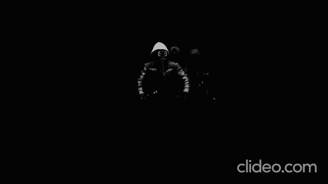a black and white photo of a person wearing a mask with the letter j visible