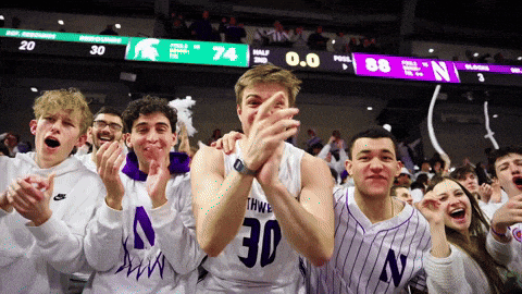a basketball player with the number 30 on his jersey applauds