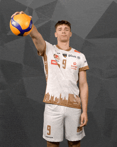 a man wearing a number 9 jersey holds a volleyball