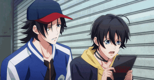 two anime characters are looking at a tablet and one of them has a choker around his neck