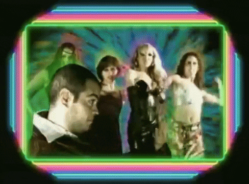 a man stands in front of a group of women dancing