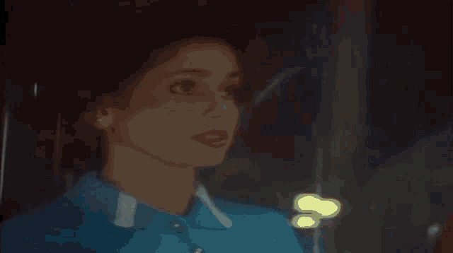 a blurred image of a man 's face with a blue background