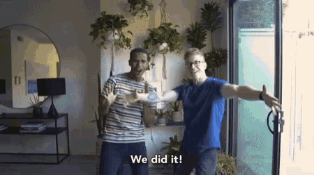 two men are standing in front of a sliding glass door with the words " we did it " on the bottom