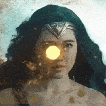 a close up of a woman 's face wearing a wonder woman costume