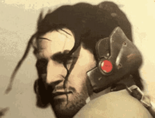 a close up of a man wearing a helmet with a red button on it 's head .