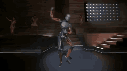 a robot is dancing on a stage with people watching