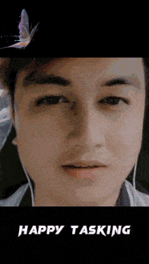 a close up of a man 's face with the words happy tasking written below it