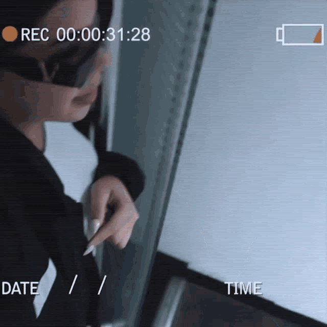 a recording of a woman 's face with the time of 00:31:28 on the screen