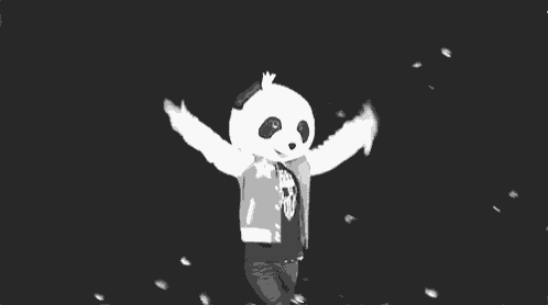a black and white photo of a person wearing a mascot costume .