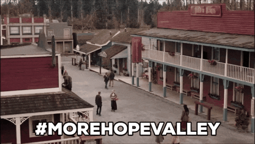 a sign that says #morehopevalley in front of a small town