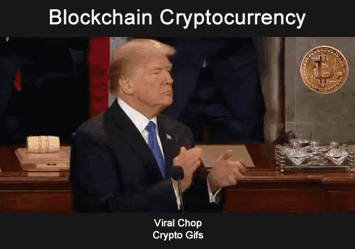 a man in a suit and tie is clapping in front of a microphone with the words blockchain cryptocurrency above him
