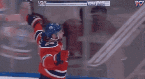an edmonton oilers hockey player celebrates his goal with his teammates
