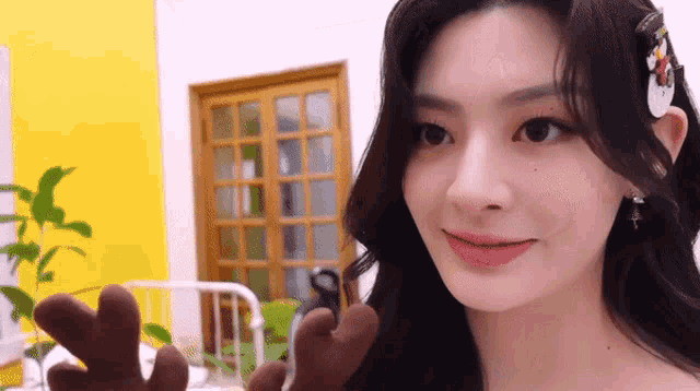 a close up of a woman holding a stuffed animal in her hand