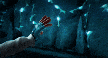 a robotic hand reaches out to a human hand