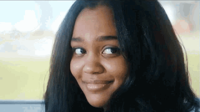 a close up of a young woman making a funny face while looking at the camera .