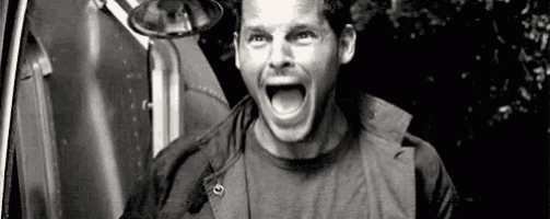 a man is screaming in a black and white photo .