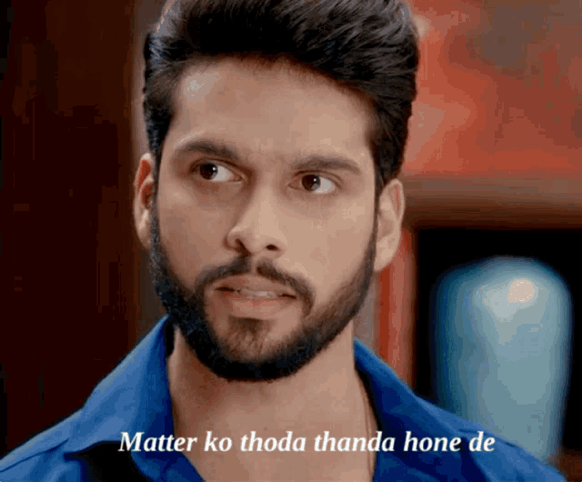 a man with a beard wearing a blue shirt with the words matter ko thoda thanda hone de