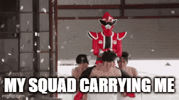 a man in a red superhero costume is carrying another man on his shoulders .