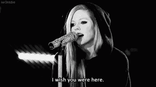 a woman singing into a microphone with the words i wish you were here