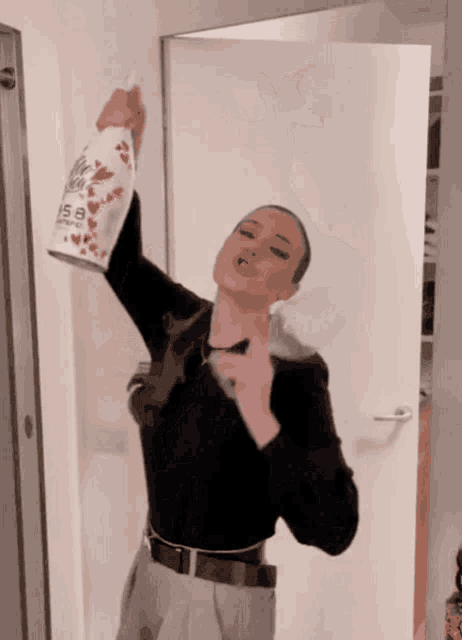 a woman is holding a bottle of isa champagne