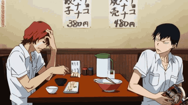 two anime characters sitting at a table with chinese writing on the wall