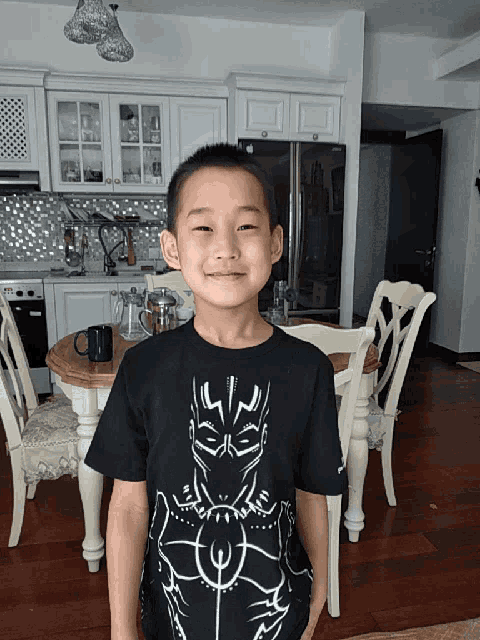 a young boy wearing a black panther shirt