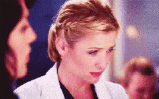 a woman in a white coat with a braided ponytail