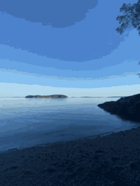 a large body of water with a few small islands in the distance
